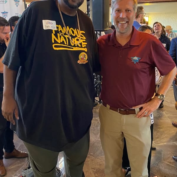 Frank Willis, owner of Frank's Famous Chicken & Waffles, poses with another man at an event.
